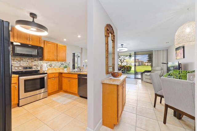 68-3840 Lua Kula St Unit H100, Waikoloa, HI 96738 - kitchen with black appliances, open floor plan, backsplash, light tile patterned floors, and light countertops