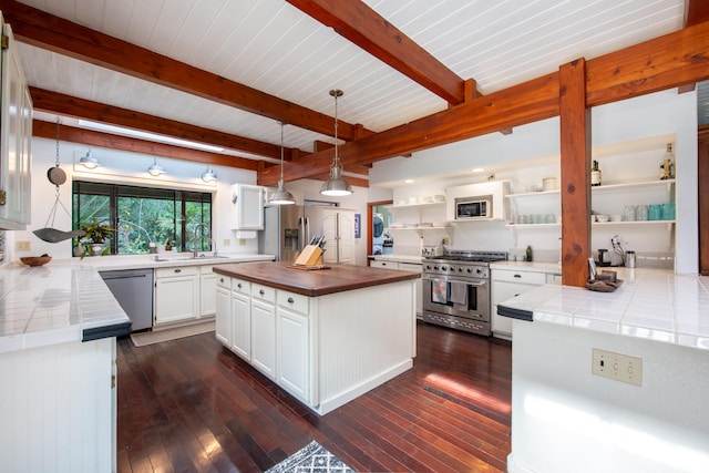 45-1070 Kalehua Rd, Honokaa, HI 96727 - kitchen featuring stainless steel appliances, open shelves, dark wood-style floors, white cabinets, and beamed ceiling