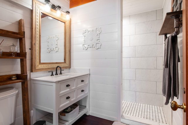 45-1070 Kalehua Rd, Honokaa, HI 96727 - bathroom with tiled shower, vanity, toilet, and wood finished floors