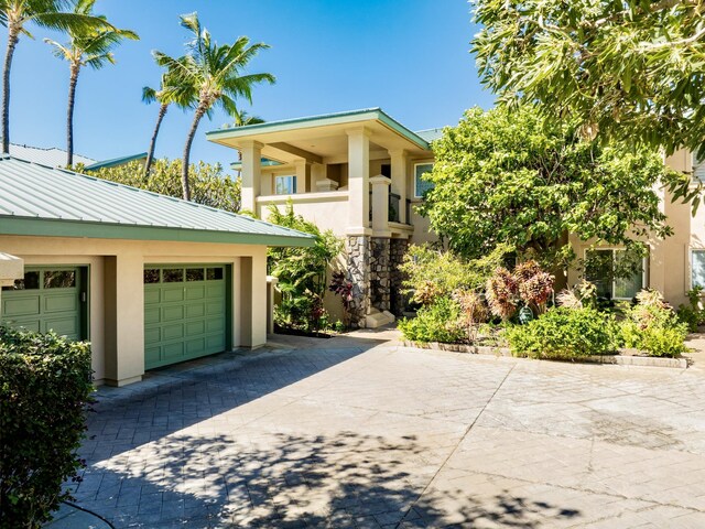 62-3614 Lolii Way Unit E-2, Kamuela, HI 96743 - view of front of home with stucco siding, driveway, and metal roof
