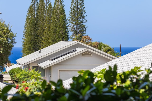 75-217 Nani Kailua Dr Unit 149, Kailua-Kona, HI 96740 - view of front of house featuring a water view, an attached garage, and a shingled roof