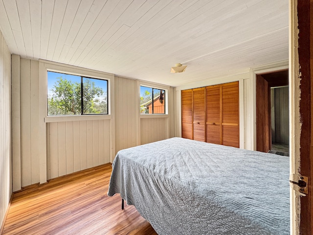 94-2664 Lorenzo Rd, Naalehu, HI 96772 - bedroom with wood finished floors, wood ceiling, a closet, and wooden walls