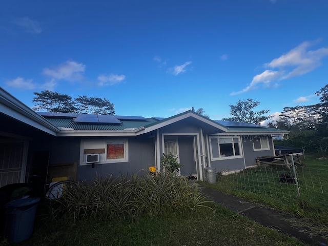 15-1509 22nd Ave, Keaau, HI 96749 - view of front of home featuring solar panels, metal roof, and cooling unit