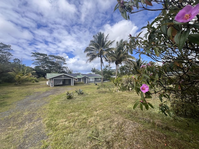 15-1509 22nd Ave, Keaau, HI 96749 - view of front facade with dirt driveway, a front lawn, and a carport