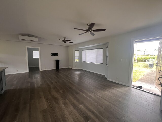 15-1509 22nd Ave, Keaau, HI 96749 - unfurnished living room with a wall mounted air conditioner, plenty of natural light, and dark wood-type flooring