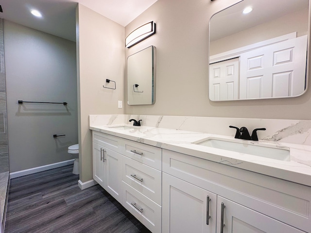 15-1878 31st Ave, Keaau, HI 96749 - full bath with double vanity, wood finished floors, toilet, baseboards, and recessed lighting