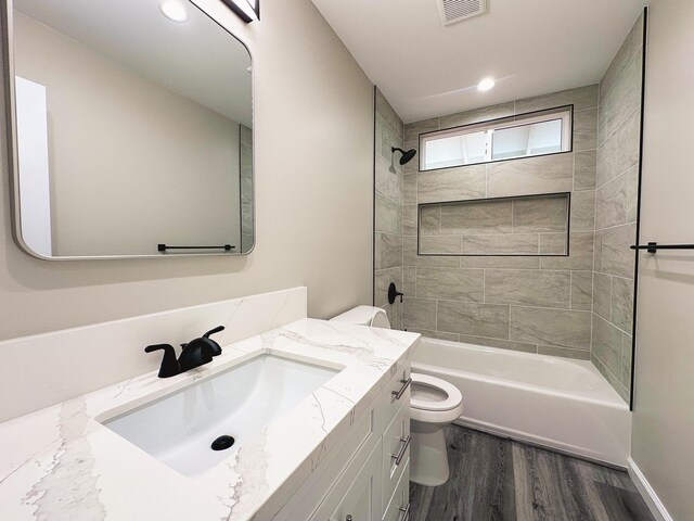 15-1878 31st Ave, Keaau, HI 96749 - bathroom featuring toilet, wood finished floors, vanity, bathtub / shower combination, and recessed lighting