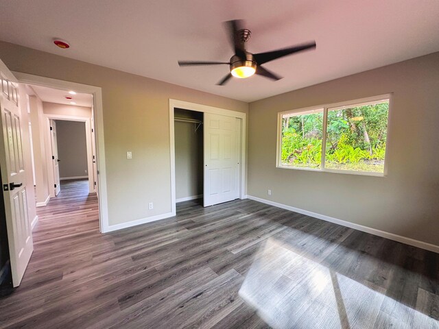 15-1878 31st Ave, Keaau, HI 96749 - unfurnished bedroom with baseboards, dark wood-style floors, a closet, and ceiling fan