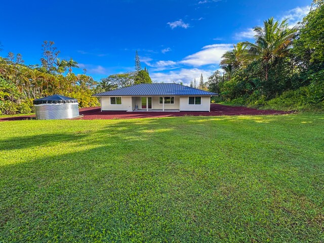 15-1878 31st Ave, Keaau, HI 96749 - rear view of house with a yard and metal roof
