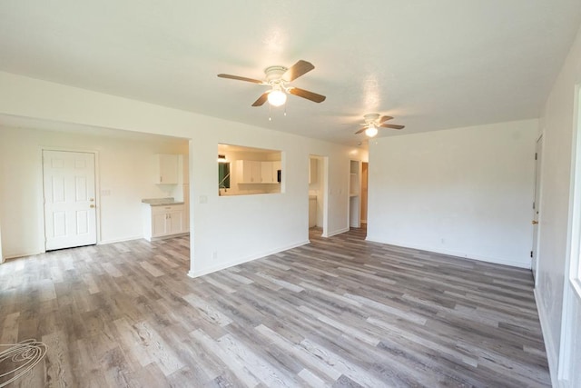 15-2746 Lai St, Pahoa, HI 96778 - unfurnished living room with a ceiling fan, wood finished floors, and baseboards