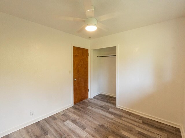 15-2746 Lai St, Pahoa, HI 96778 - unfurnished bedroom featuring wood finished floors, a closet, baseboards, and a ceiling fan