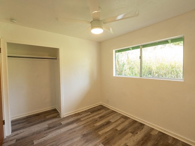 15-2746 Lai St, Pahoa, HI 96778 - unfurnished bedroom with dark wood-type flooring, a closet, baseboards, and a ceiling fan