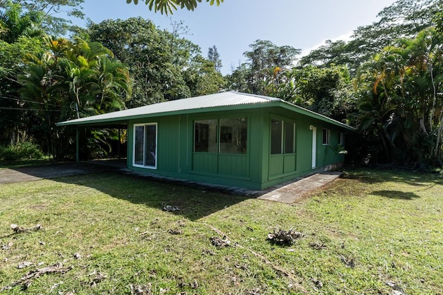 15-2746 Lai St, Pahoa, HI 96778 - view of home's exterior with a lawn, board and batten siding, and an attached carport