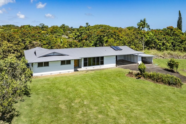 27-296 Kaieie Rd, Papaikou, HI 96781 - view of front of home with a carport, a front lawn, and roof mounted solar panels