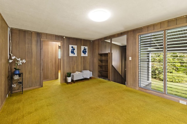 27-296 Kaieie Rd, Papaikou, HI 96781 - living room with carpet flooring, wooden walls, and plenty of natural light