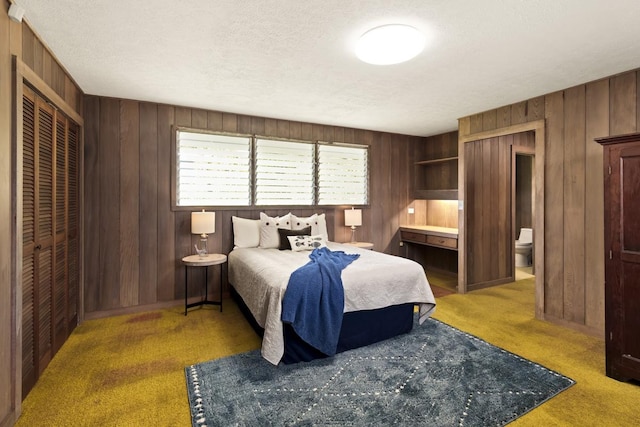 27-296 Kaieie Rd, Papaikou, HI 96781 - bedroom with wood walls, carpet, a textured ceiling, and a closet