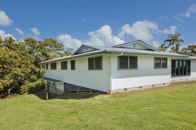 27-296 Kaieie Rd, Papaikou, HI 96781 - view of property exterior with crawl space, a yard, and metal roof