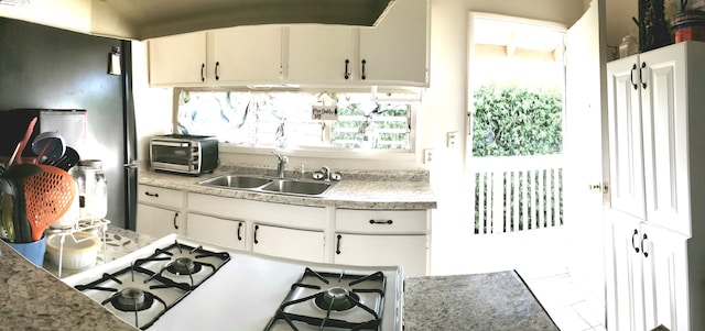 75-5724 Alahou St Unit 202A, Kailua-Kona, HI 96740 - kitchen featuring a sink, light countertops, range with gas stovetop, and white cabinets