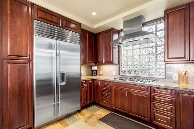 62-3600 Amaui Pl Unit F102, Kamuela, HI 96743 - kitchen featuring stainless steel appliances, exhaust hood, tasteful backsplash, light stone countertops, and dark brown cabinets