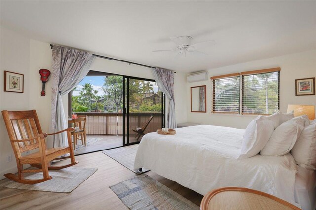 78-261 Manukai St Unit 3403, Kailua-Kona, HI 96740 - bedroom with an AC wall unit, access to exterior, wood finished floors, and a ceiling fan