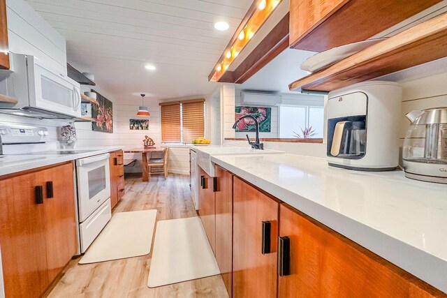 78-261 Manukai St Unit 3403, Kailua-Kona, HI 96740 - kitchen with white appliances, light wood-type flooring, brown cabinetry, a sink, and recessed lighting