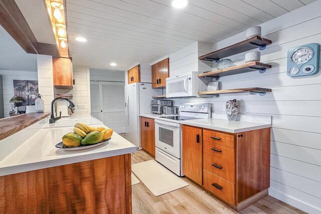 78-261 Manukai St Unit 3403, Kailua-Kona, HI 96740 - kitchen featuring white appliances, light wood-type flooring, brown cabinetry, a sink, and recessed lighting