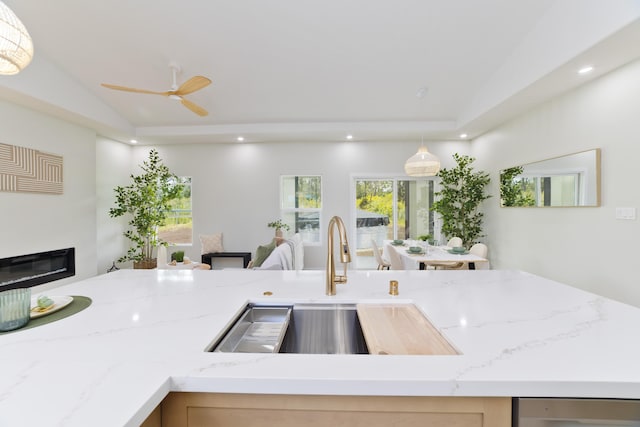 16-2050 Coconut Dr, Pahoa, HI 96778 - kitchen with a glass covered fireplace, light stone countertops, recessed lighting, lofted ceiling, and decorative light fixtures
