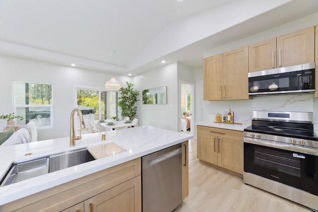 16-2050 Coconut Dr, Pahoa, HI 96778 - kitchen featuring stainless steel appliances, light brown cabinetry, vaulted ceiling, recessed lighting, and light stone countertops