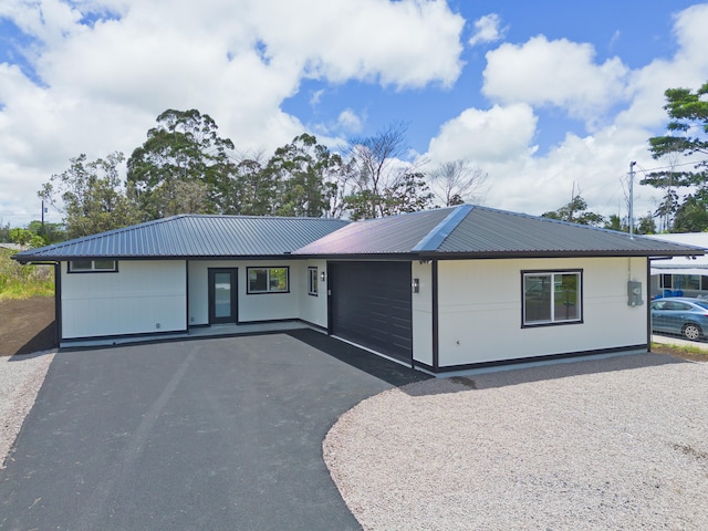 16-2050 Coconut Dr, Pahoa, HI 96778 - ranch-style house with driveway, a garage, and a metal roof