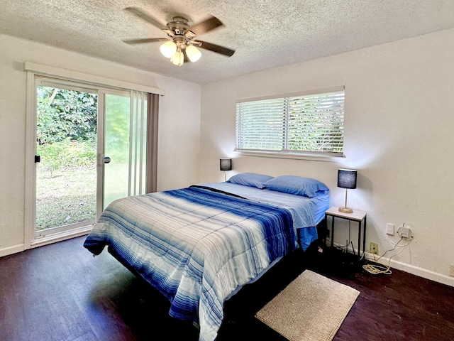 15-240 N Puni Makai Loop, Pahoa, HI 96778 - bedroom featuring access to outside, baseboards, multiple windows, wood finished floors, and a textured ceiling