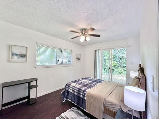 15-240 N Puni Makai Loop, Pahoa, HI 96778 - bedroom with dark wood-style floors, a textured ceiling, baseboards, and ceiling fan