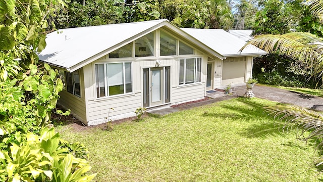 15-240 N Puni Makai Loop, Pahoa, HI 96778 - back of property featuring a garage, a yard, and driveway
