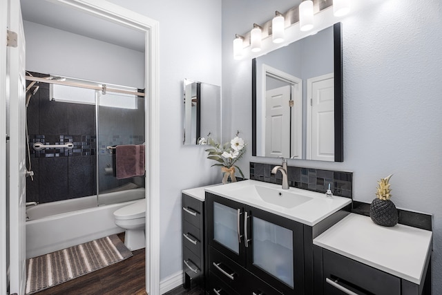 73-4100 Kulanui Pl, Kailua-Kona, HI 96740 - full bath featuring toilet, vanity, wood finished floors, bath / shower combo with glass door, and tasteful backsplash