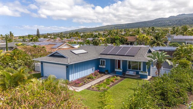 73-4365 Hau Nani St, Kailua-Kona, HI 96740 - view of front of house with roof with shingles, a garage, roof mounted solar panels, a mountain view, and a porch