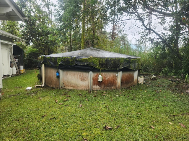 16-2126 Sugarcane Ln, Pahoa, HI 96778 - view of green lawn with a covered pool