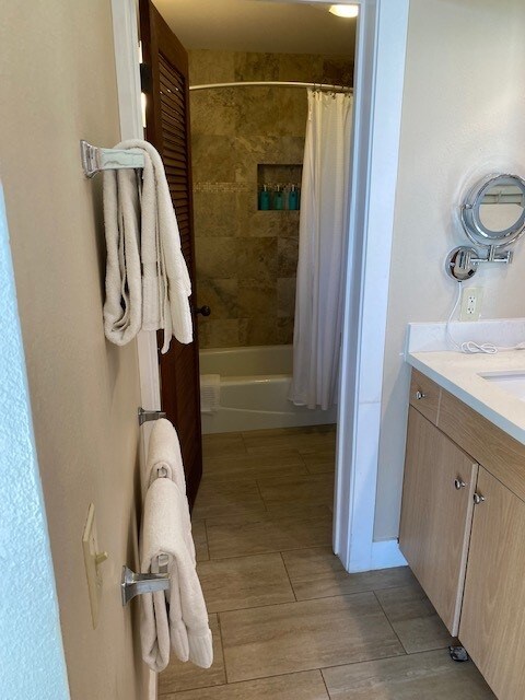 2253 Poipu Rd Unit 207, Koloa, HI 96756 - full bathroom featuring vanity, shower / bath combination with curtain, and wood finished floors