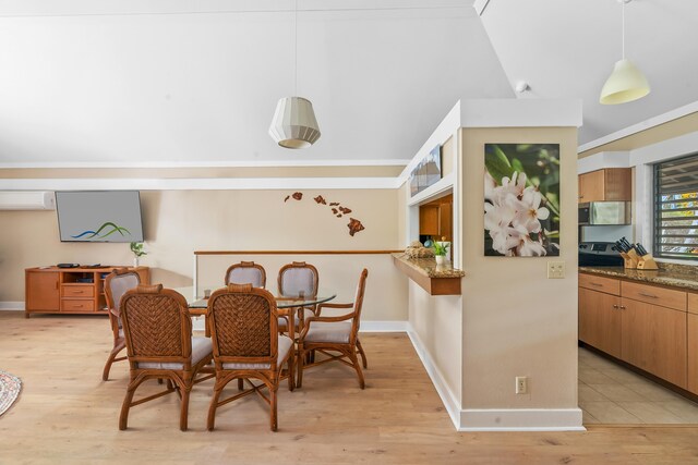 2253 Poipu Rd Unit 207, Koloa, HI 96756 - dining room featuring an AC wall unit, light wood-style floors, baseboards, and lofted ceiling