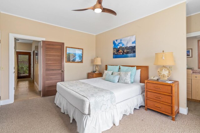 2253 Poipu Rd Unit 207, Koloa, HI 96756 - bedroom with light colored carpet, ornamental molding, baseboards, and ceiling fan