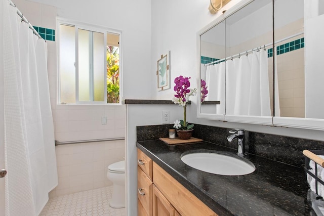 73-1125 Hamanamana St, Kailua-Kona, HI 96740 - bathroom with toilet, vanity, tile patterned flooring, tile walls, and a shower with shower curtain