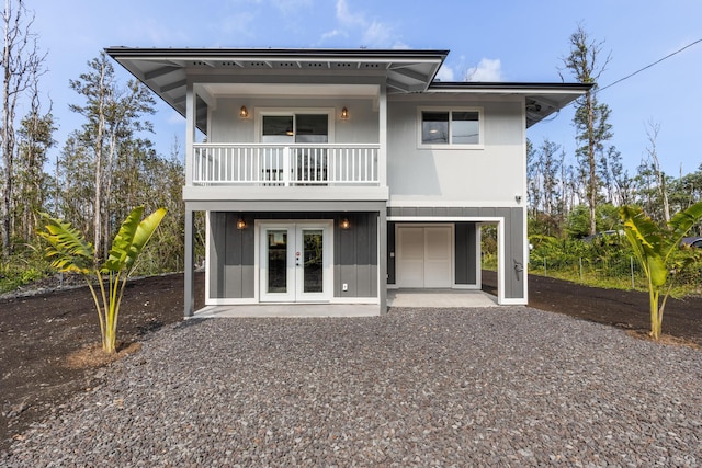16-2097 Azure Dr, Pahoa, HI 96778 - rear view of house featuring a balcony, gravel driveway, and french doors