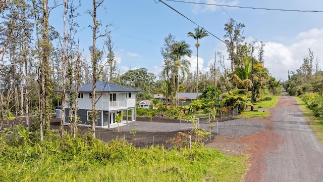16-2097 Azure Dr, Pahoa, HI 96778 - view of front of property with driveway, a balcony, and metal roof