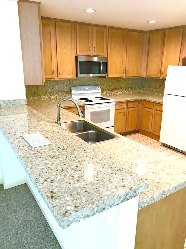 1831 Poipu Rd Unit 324, Koloa, HI 96756 - kitchen featuring white appliances, a sink, a peninsula, recessed lighting, and light stone countertops
