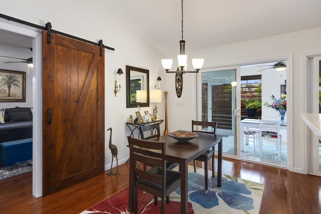 12-160 Moanauli Loop, Pahoa, HI 96778 - dining area featuring a barn door, hardwood / wood-style flooring, ceiling fan, and baseboards