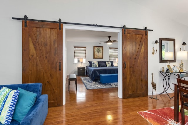 12-160 Moanauli Loop, Pahoa, HI 96778 - bedroom featuring a barn door, wood finished floors, and vaulted ceiling