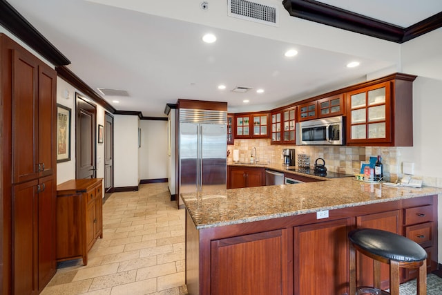 4-820 Kuhio Hwy Unit A101, Kapaa, HI 96746 - kitchen featuring stainless steel appliances, ornamental molding, a peninsula, backsplash, and recessed lighting