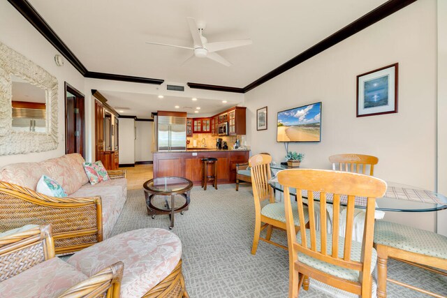 4-820 Kuhio Hwy Unit A101, Kapaa, HI 96746 - living room with ornamental molding, ceiling fan, bar, and recessed lighting