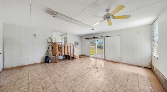 267 Hookipa Rd, Kapaa, HI 96746 - empty room featuring wood walls, a ceiling fan, and stairs