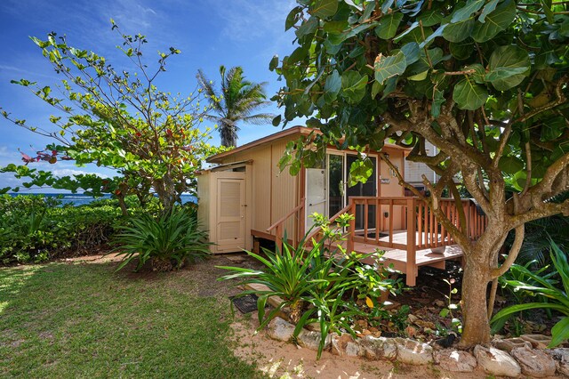 4934 Aliomanu Rd, Anahola, HI 96703 - view of grassy yard featuring a deck and an outdoor structure