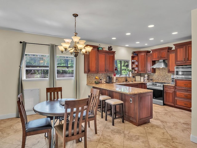 71-1371 Puu Kamanu Ln, Kailua-Kona, HI 96740 - kitchen with stainless steel gas range oven, exhaust hood, a peninsula, tasteful backsplash, and recessed lighting