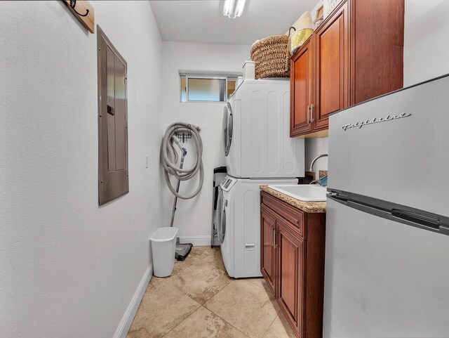 71-1371 Puu Kamanu Ln, Kailua-Kona, HI 96740 - laundry room featuring cabinet space, electric panel, stacked washer / dryer, and baseboards